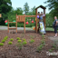Triangle Modern Nature wooden playhouse with slide bằng gỗ tự nhiên, có cầu trượt và khu vực leo trè