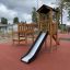 Triangle Modern Nature wooden playhouse with slide bằng gỗ tự nhiên cho khu vui chơi trẻ em.