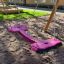 Xích đu Double Seat swing màu tím dành cho hai người trên sân chơi ngoài trời.