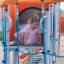 Ursa Maior castle with slide, climbing net có cấu trúc ống và lưới leo núi màu cam và xanh.