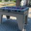 Bàn chơi Football Table Game ngoài trời với các tay cầm và người chơi màu đỏ và xanh.